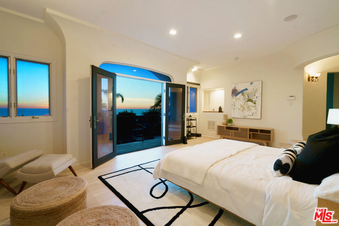 7112 Rindge Avenue Playa del Rey, CA 90293 - Photo 12 of 39 a bedroom with a bed and glass wall