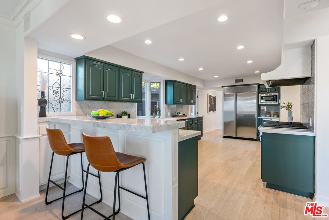 7112 Rindge Avenue Playa del Rey, CA 90293 - Photo 7 of 39 a kitchen with stainless steel appliances kitchen island granite countertop a refrigerator and a sink