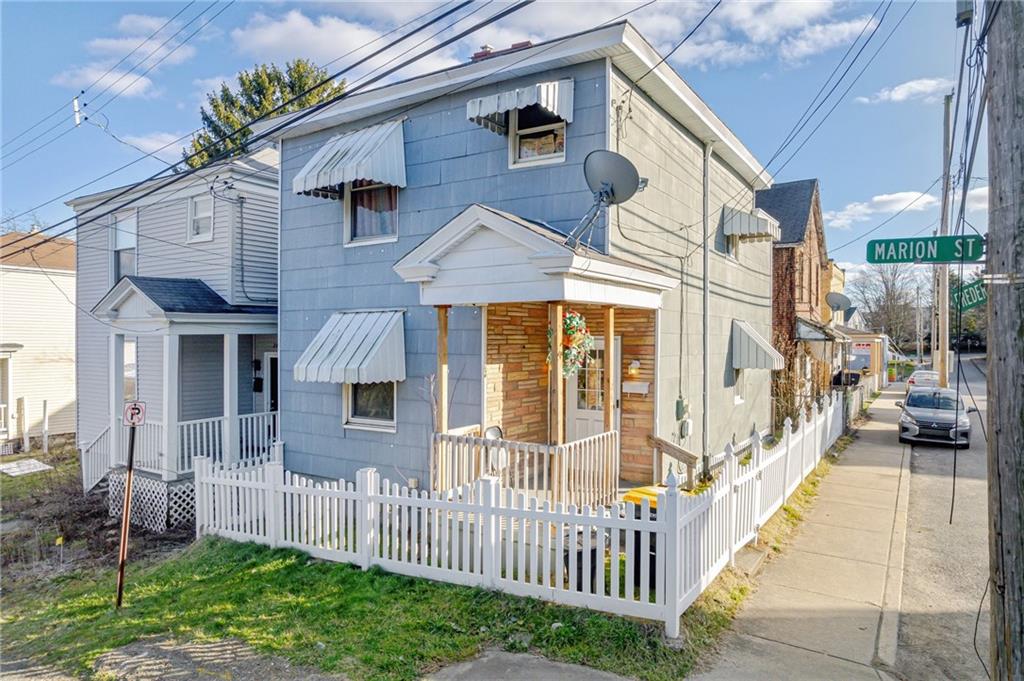 247 Marion Street McKees Rocks, PA 15136 - Photo 1 of 19 a view of a house with wooden fence and a porch