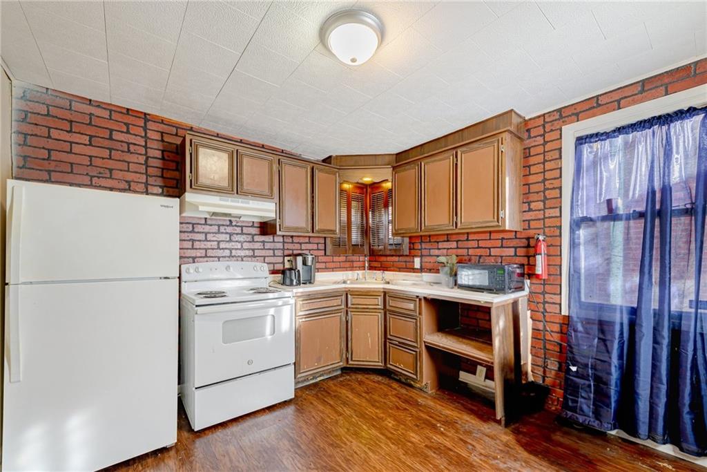 247 Marion Street McKees Rocks, PA 15136 - Photo 5 of 19 a kitchen with a sink cabinets stainless steel appliances and a window