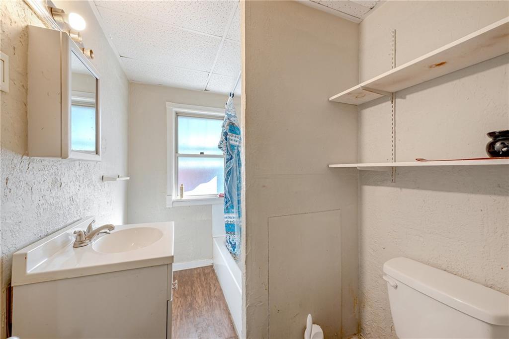 247 Marion Street McKees Rocks, PA 15136 - Photo 10 of 19 a bathroom with a sink a toilet and mirror