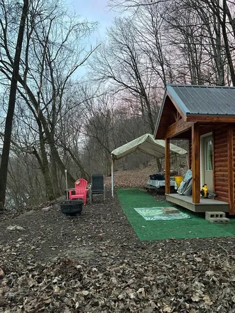 a view of a small house with backyard