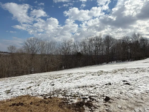 a view of side of snow with yard
