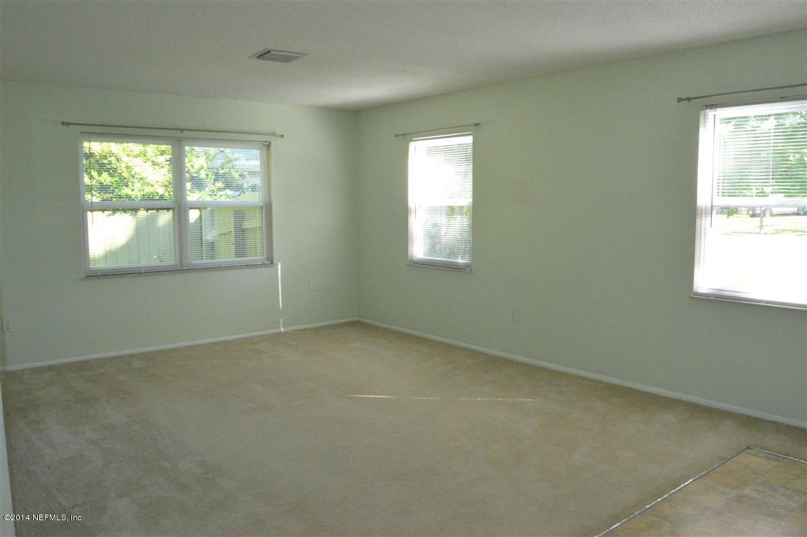 226 Lily Road St. Augustine, FL 32086 - Photo 3 of 24 an empty room with a window