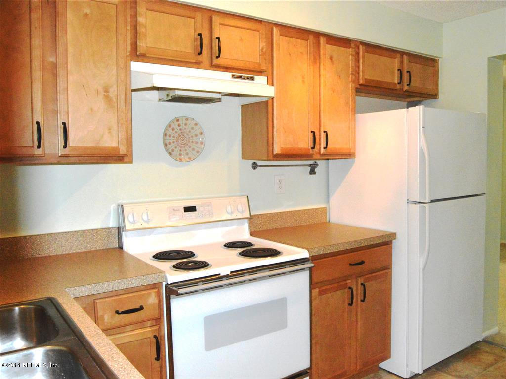 226 Lily Road St. Augustine, FL 32086 - Photo 8 of 24 a kitchen with a stove and a refrigerator
