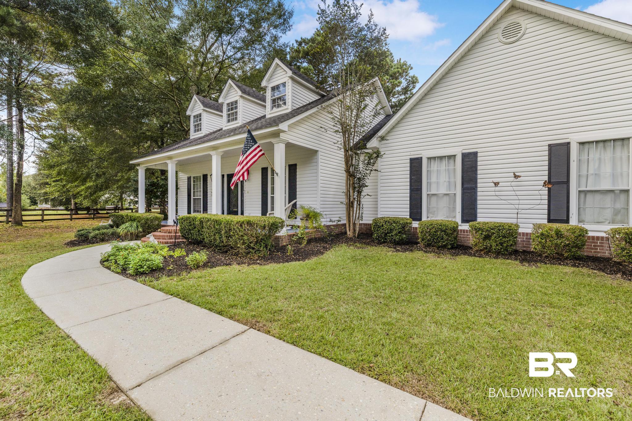 10603 Old Stage Road Stockton, AL 36579 - Photo 6 of 34 Cape cod home featuring covered porch and a shingled roof