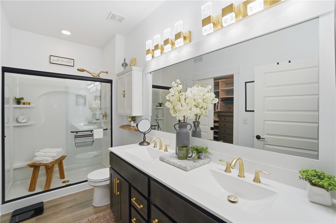 605 Cape Cod Court Beavercreek, OH 45430 - Photo 27 of 54 This spacious bathroom features a double vanity and a glass-enclosed shower.