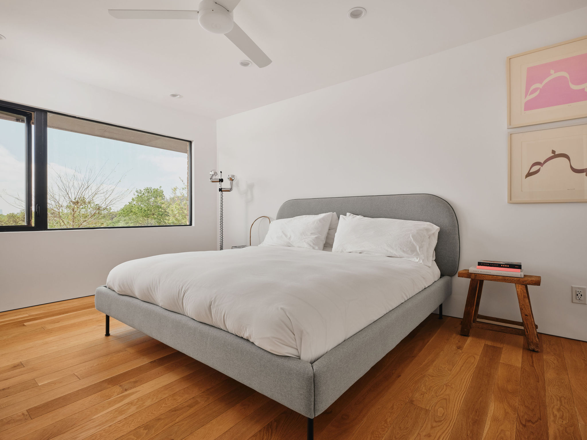 Undisclosed Address Austin, TX 78731 - Photo 21 of 26 Hardwood floors and a wide window frame a private outdoor vista.