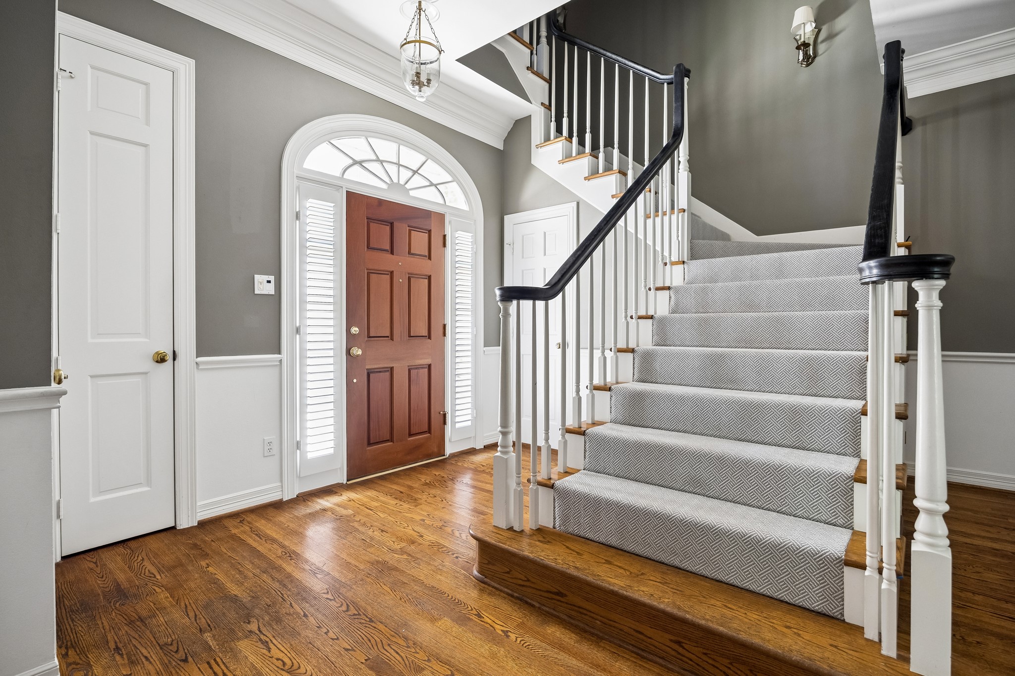 6022 Burgoyne Road Houston, TX 77057 - Photo 12 of 30 Welcoming foyer with hardwood floors, elegant millwork, and a sweeping staircase creating a striking first impression.