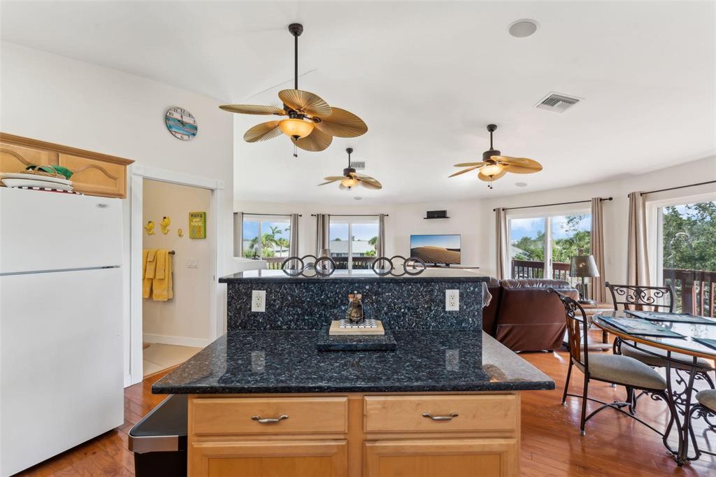 16361 Stringfellow Road Bokeelia, FL 33922 - Photo 14 of 26 a view of kitchen island with granite countertop furniture and a refrigerator
