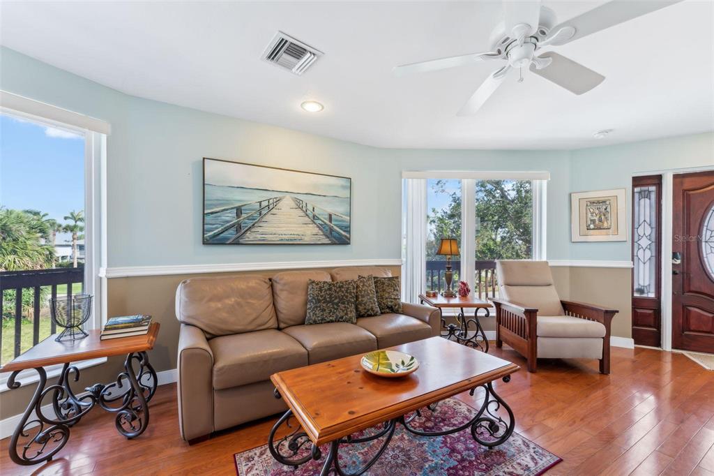16361 Stringfellow Road Bokeelia, FL 33922 - Photo 18 of 26 a living room with furniture a table and a large window