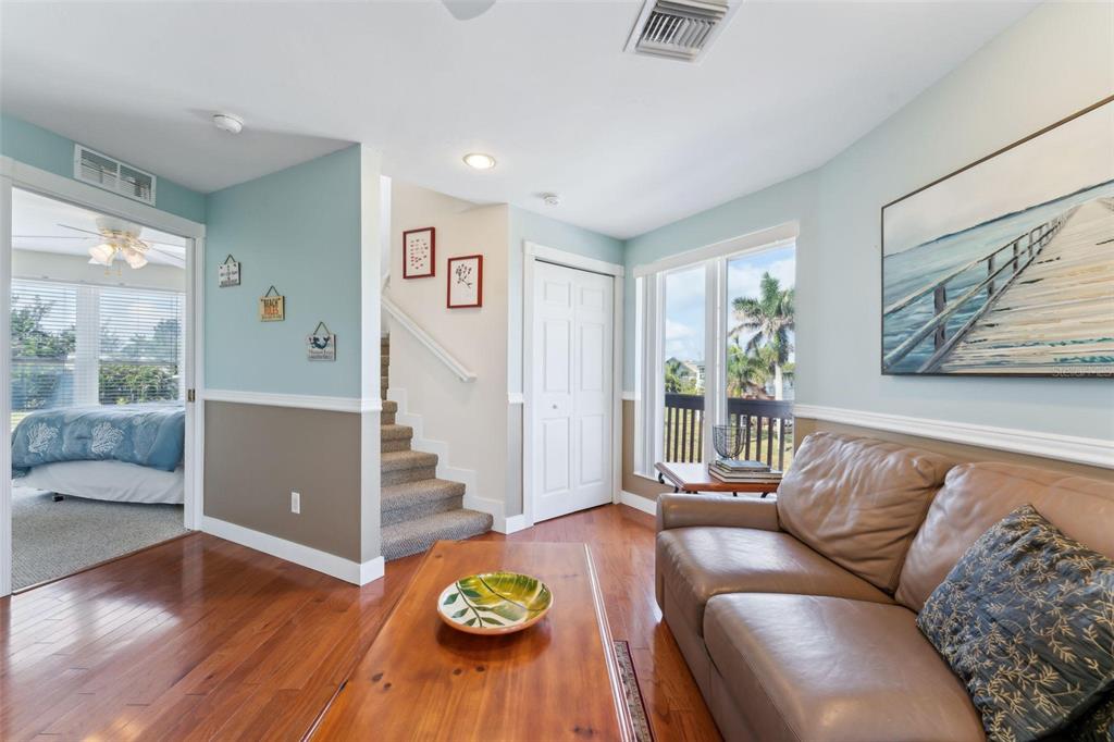 16361 Stringfellow Road Bokeelia, FL 33922 - Photo 20 of 26 a living room with furniture and wooden floor