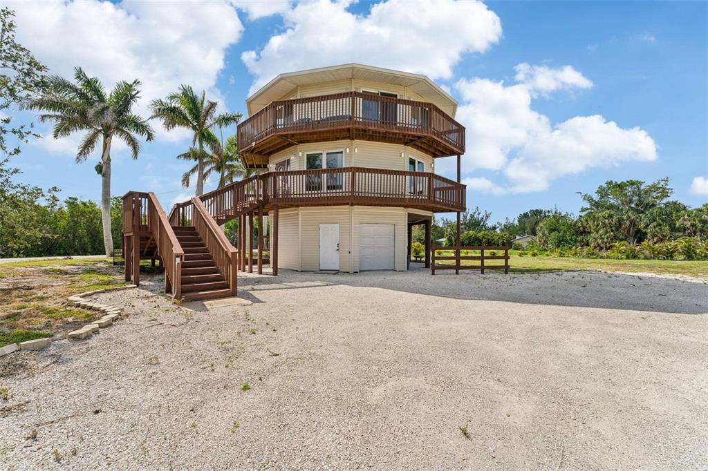 16361 Stringfellow Road Bokeelia, FL 33922 - Photo 2 of 26 a front view of a house with a yard