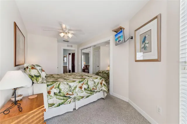 a bedroom with bed and a chandelier