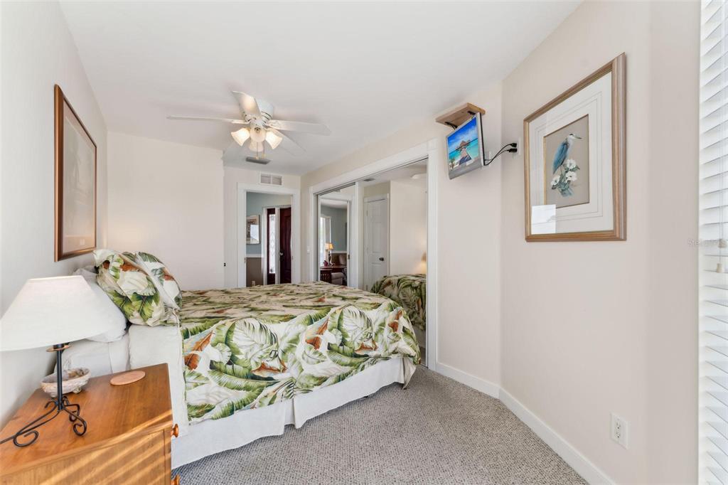 16361 Stringfellow Road Bokeelia, FL 33922 - Photo 23 of 26 a bedroom with bed and a chandelier