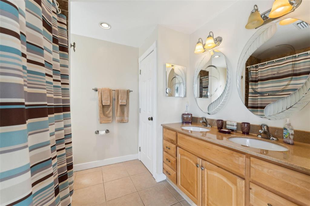 16361 Stringfellow Road Bokeelia, FL 33922 - Photo 24 of 26 a spacious bathroom with a double vanity sink mirror and