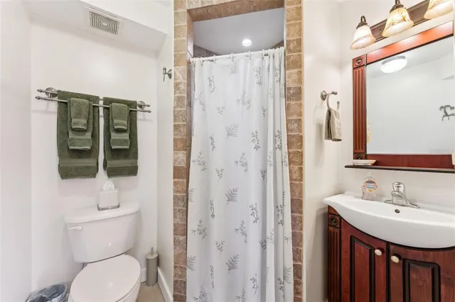 a bathroom with a toilet a sink and shower