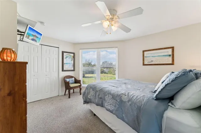 a bed room with a bed and a chair