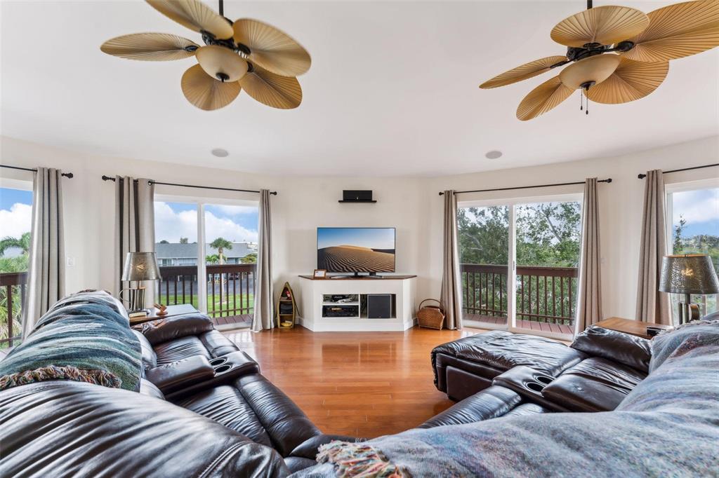 16361 Stringfellow Road Bokeelia, FL 33922 - Photo 7 of 26 a living room with furniture ceiling fan and a large window
