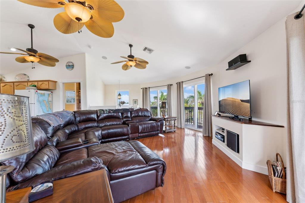 16361 Stringfellow Road Bokeelia, FL 33922 - Photo 8 of 26 a living room with furniture kitchen view and a wooden floor