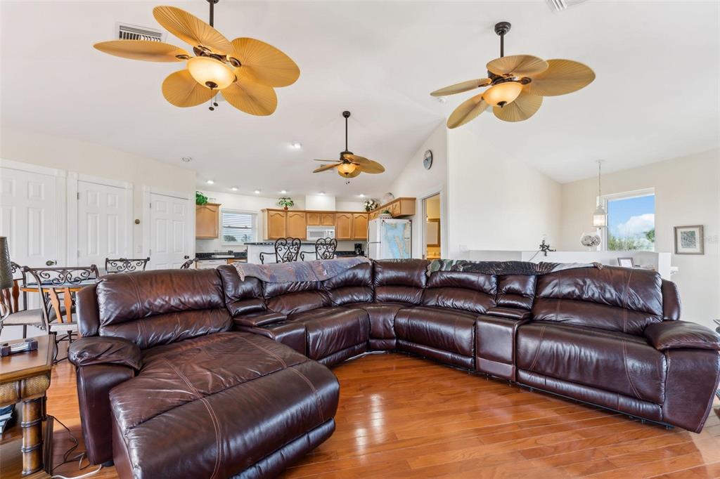 16361 Stringfellow Road Bokeelia, FL 33922 - Photo 9 of 26 a living room with furniture kitchen view and a chandelier