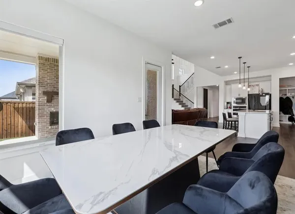 a living room with stainless steel appliances kitchen island granite countertop furniture and a large window