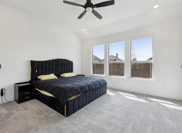 a spacious bedroom with a bed and window