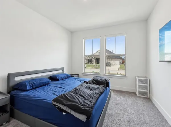 a bedroom with a bed and window