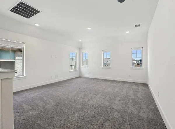 an empty room with windows and pillars in it