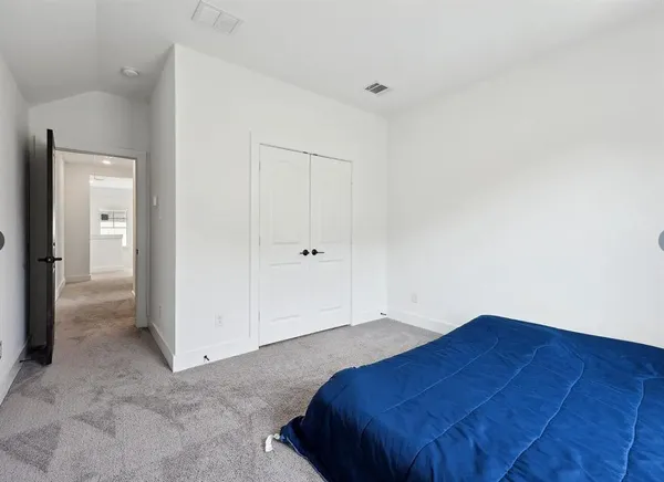 a bedroom with a bed and a painting on the wall