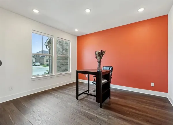 a room with wooden floor and furniture