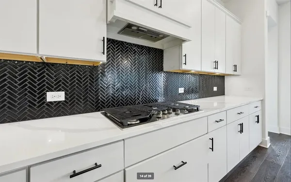 a kitchen with granite countertop white cabinets and white appliances