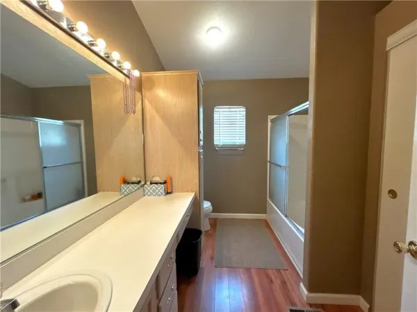 a spacious bathroom with a double vanity sink and a mirror
