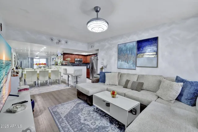 a living room with furniture and a chandelier