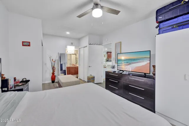 a bedroom with a bed and a flat screen tv