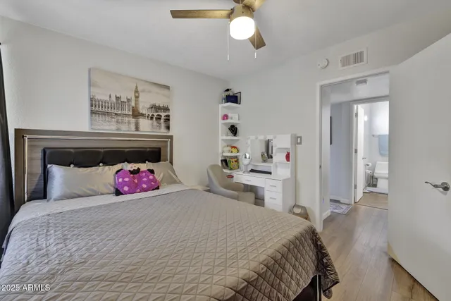 a bedroom with a bed and cabinets