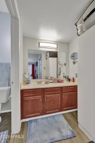 a spacious bathroom with a granite countertop sink and a mirror