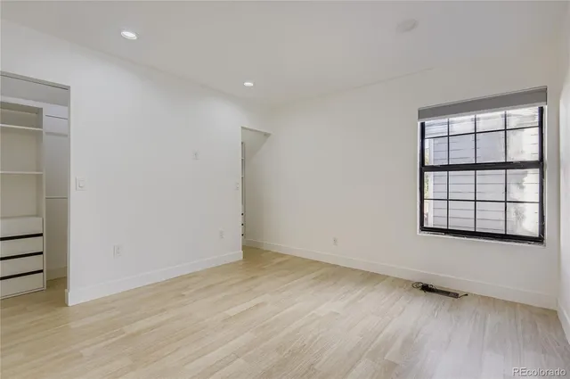 a view of an empty room with a closet