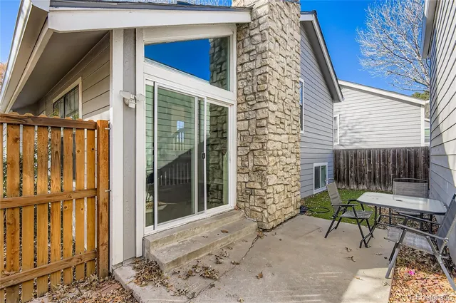 a view of house with backyard and sitting area