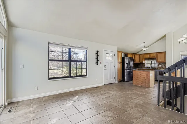 a view of a hallway with entryway and chandelier