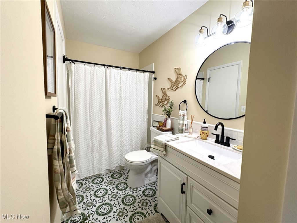4015 Marks Road, Unit 3C Medina, OH 44256 - Photo 15 of 36 Bathroom with tile patterned flooring, vanity, a textured ceiling, and toilet