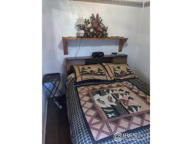 a bedroom with a bed and a potted plant