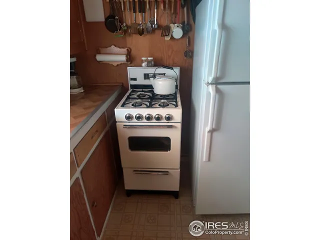a stove top oven sitting inside of a kitchen