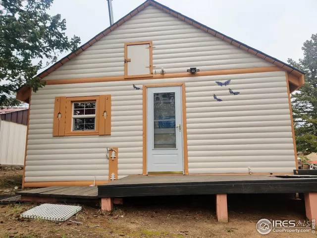 a view of a house with a balcony and wooden fence