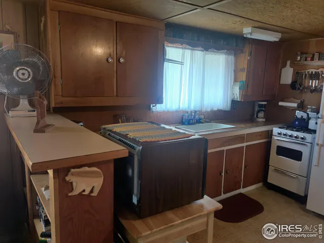 a kitchen that has a sink and a stove in it