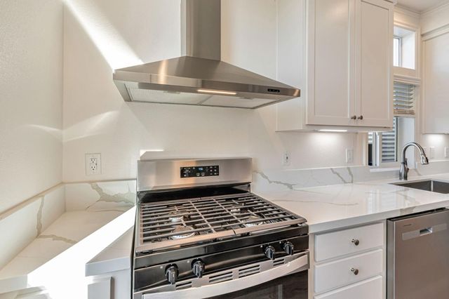 a kitchen with a refrigerator and cabinets