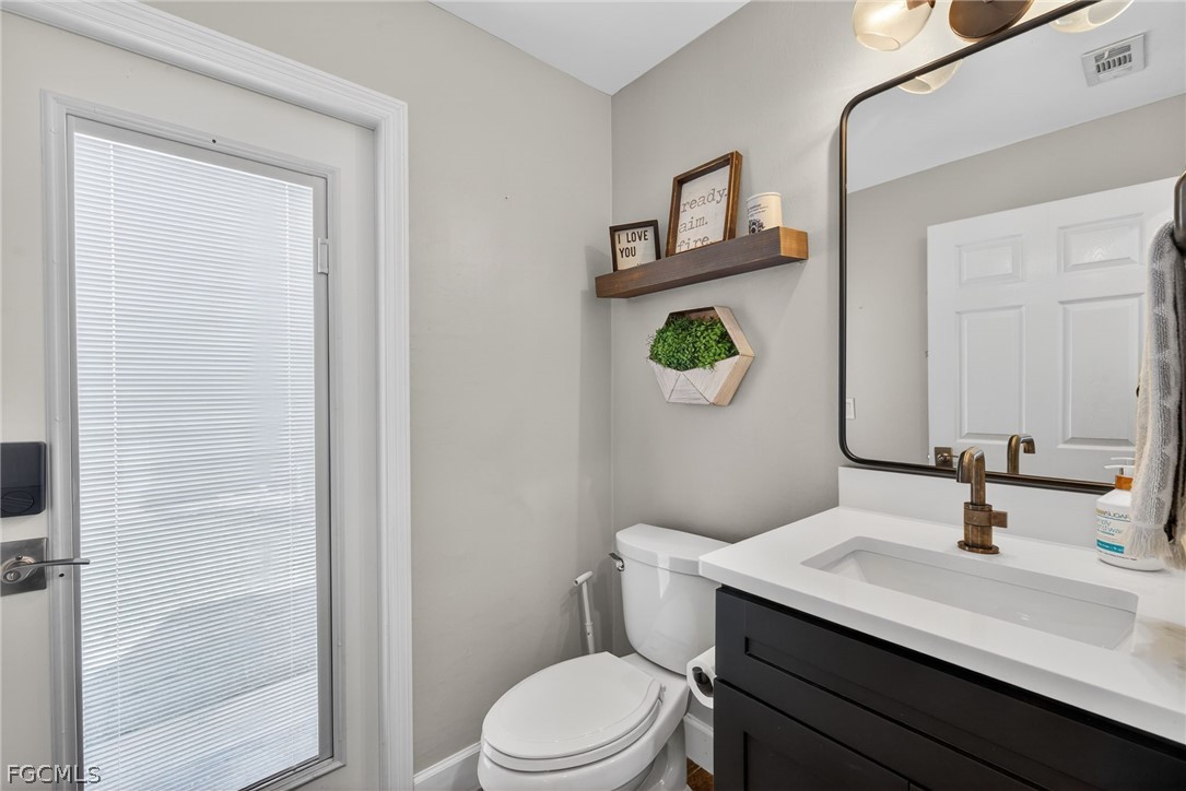 22866 Forest Ridge Drive Estero, FL 33928 - Photo 26 of 38 a bathroom with a toilet sink and mirror