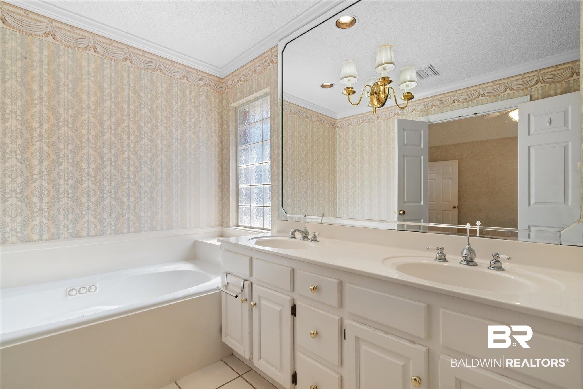 2220 Irongate Court Mobile, AL 36695 - Photo 12 of 20 Bathroom featuring ornamental molding, tile patterned flooring, a sink, and wallpapered walls