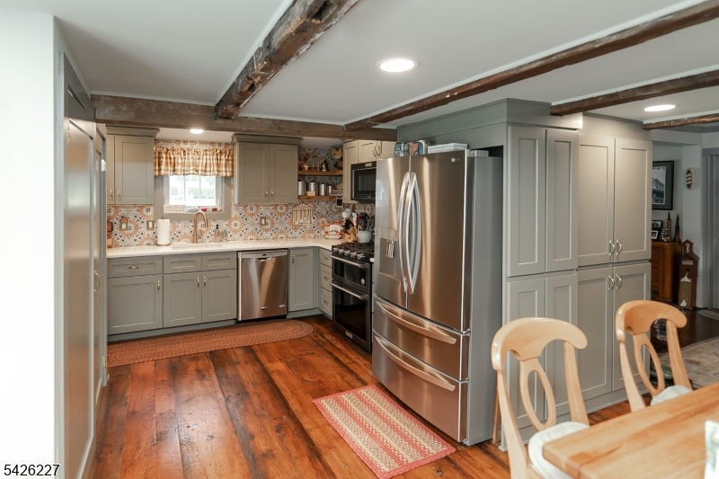 36 Main Street Flanders, NJ 07836 - Photo 14 of 49 a kitchen with blue cabinets a sink and stainless steel appliances