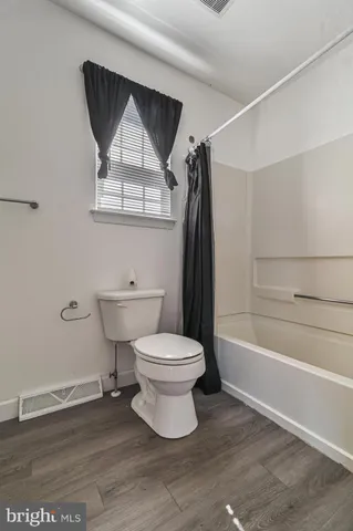a bathroom with a toilet and a bathtub